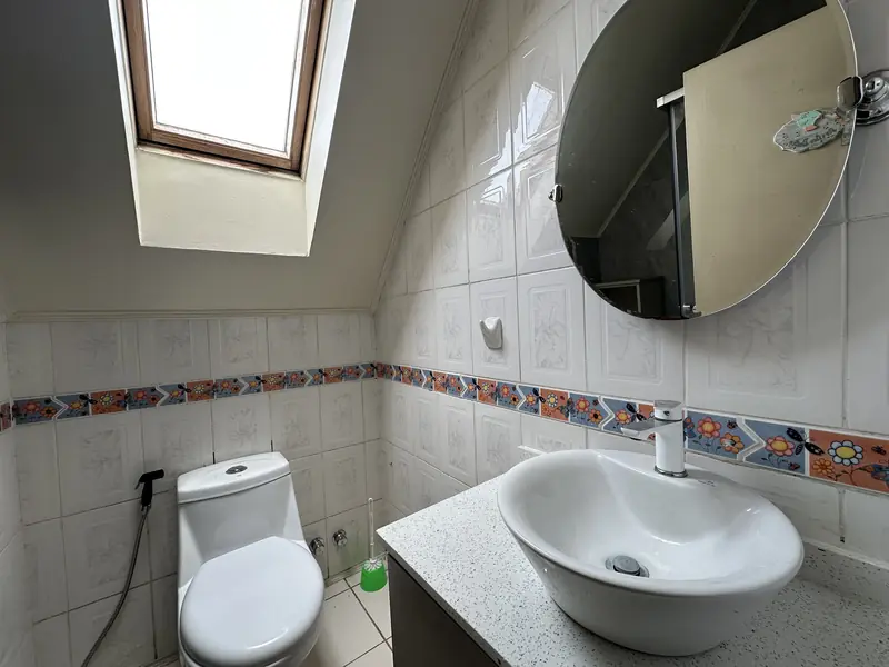 Baño con lucarna de la casa en arriendo en Altos del Maipo, Temuco